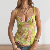 Woman wearing a floral yellow top with jewelry on a light background